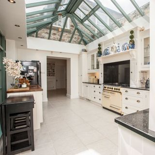 kitchen with white painted units and a ceramic tiled flooring