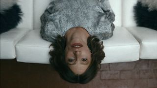 Sofía Vergara as Griselda upside down on the couch in Griselda episode 6