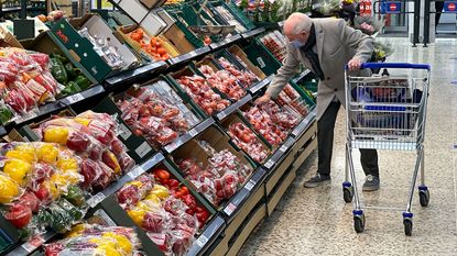 Man picking fruit in a supermarket