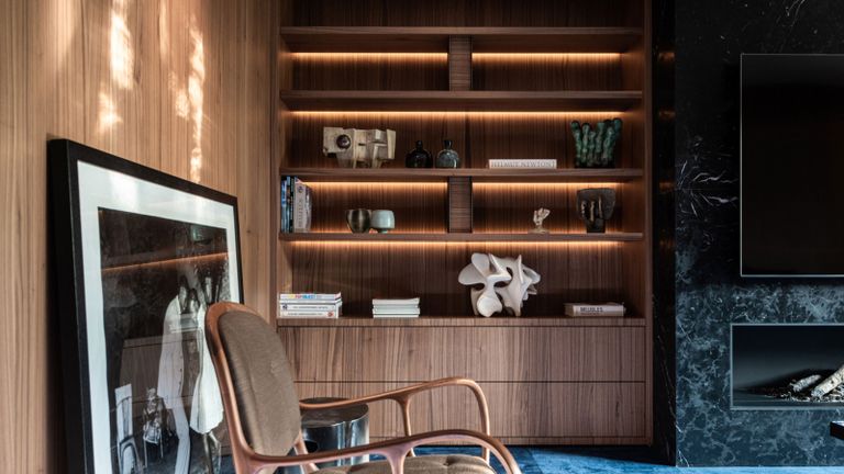 a bookshelf with integrated lighting and stylish decor
