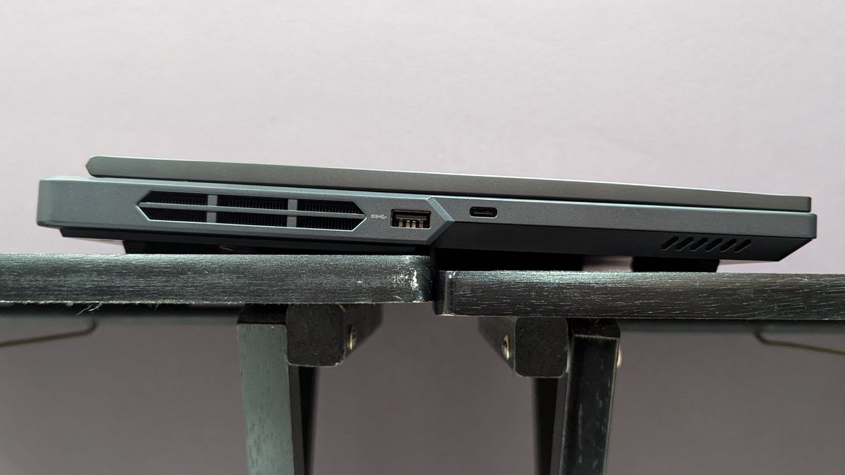 Lenovo Legion Pro 5i closed on a black table, highlighting the ports on the left, including USB Type-A and USB Type-C.