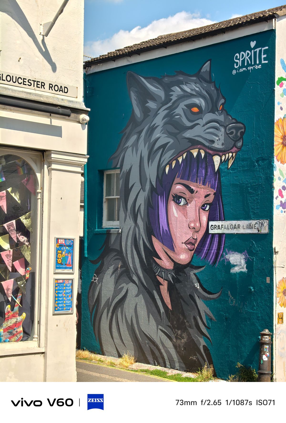 Graffiti of a girl wearing a hood made from a wolf's head