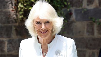 Queen Camilla's Scallop Shell Brooch seen as she visits Eastlands Library