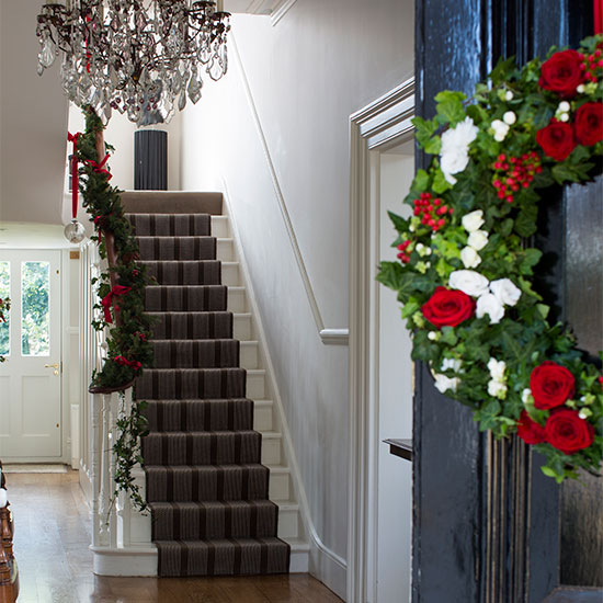 hallway with white wall and staircase