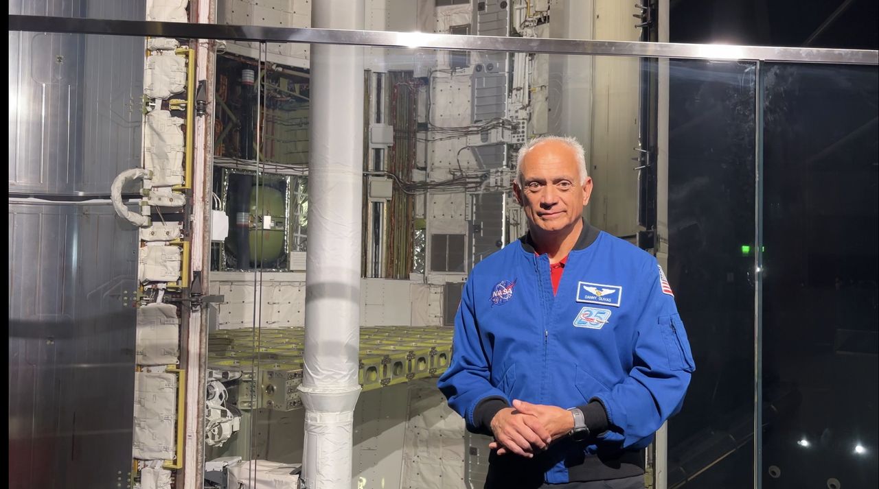 Former NASA astronaut Danny Olivas stands with the Space Shuttle Endeavor.