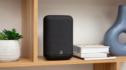 Bluesound Pulse Flex speaker in black on a bookshelf