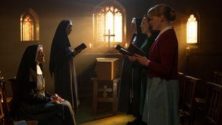 The nurses and nuns sing next to a coffin in the Nonnatus House chapel