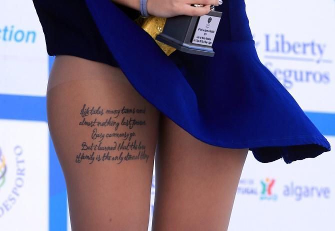 The legs of a podium hostess at the Volta Ao Algarve