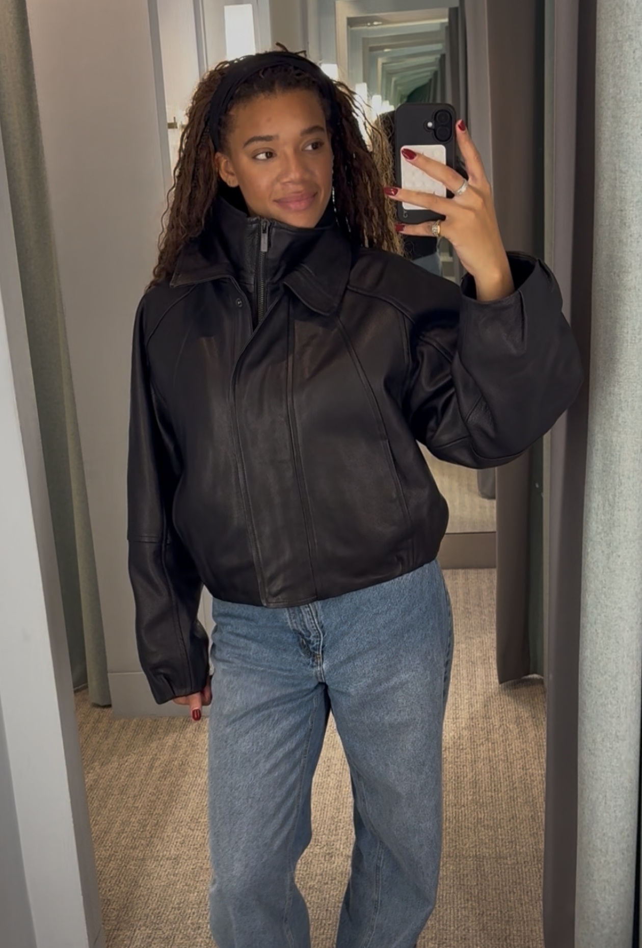 @imani_athina wearing a leather jacket outfit.