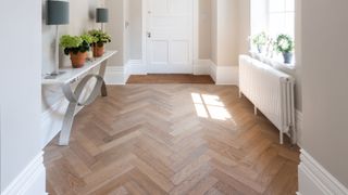 pale herringbone wooden flooring in grand hallway