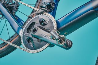 Trek Checkpoint SL 7 closeup of sram force axs chainset on blue background