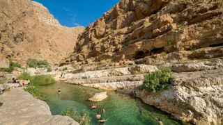 People swimming in Wadi Shab pools in Oman