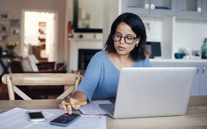 picture of woman working on her taxes at her computer