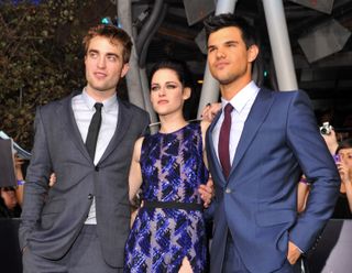 Actors Robert Pattinson, Kristen Stewart and Taylor Lautner arrive at the Los Angeles premiere of "The Twilight Saga: Breaking Dawn Part 1."