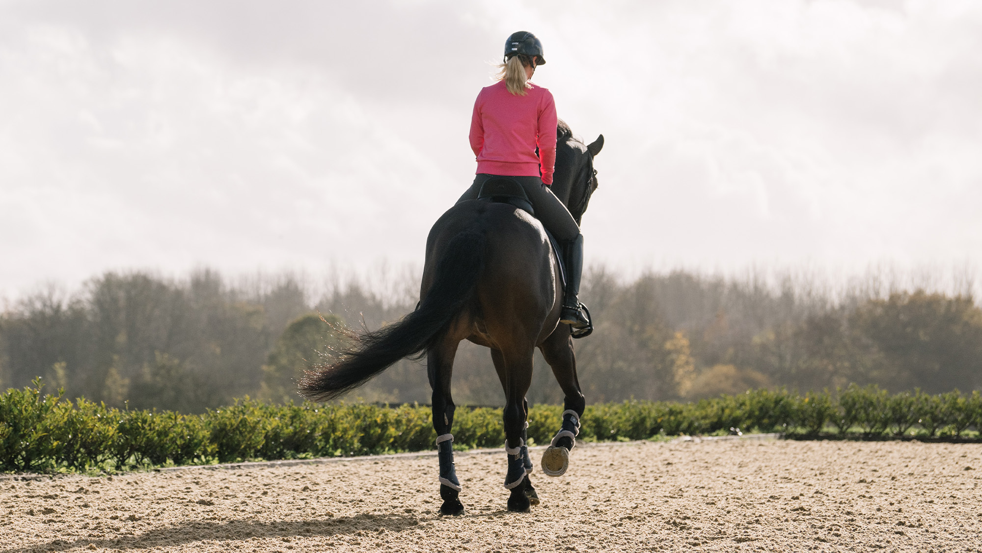 Laura Tomlinson cantering away from the camera