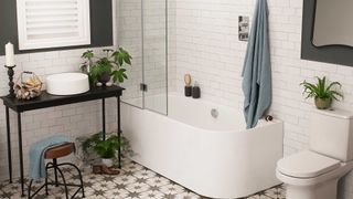 white bathroom with star pattern floor tiles and shower bath