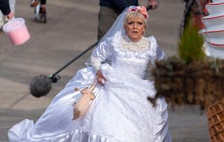 EastEnders Jean Slater running in a wedding dress looking panicked.