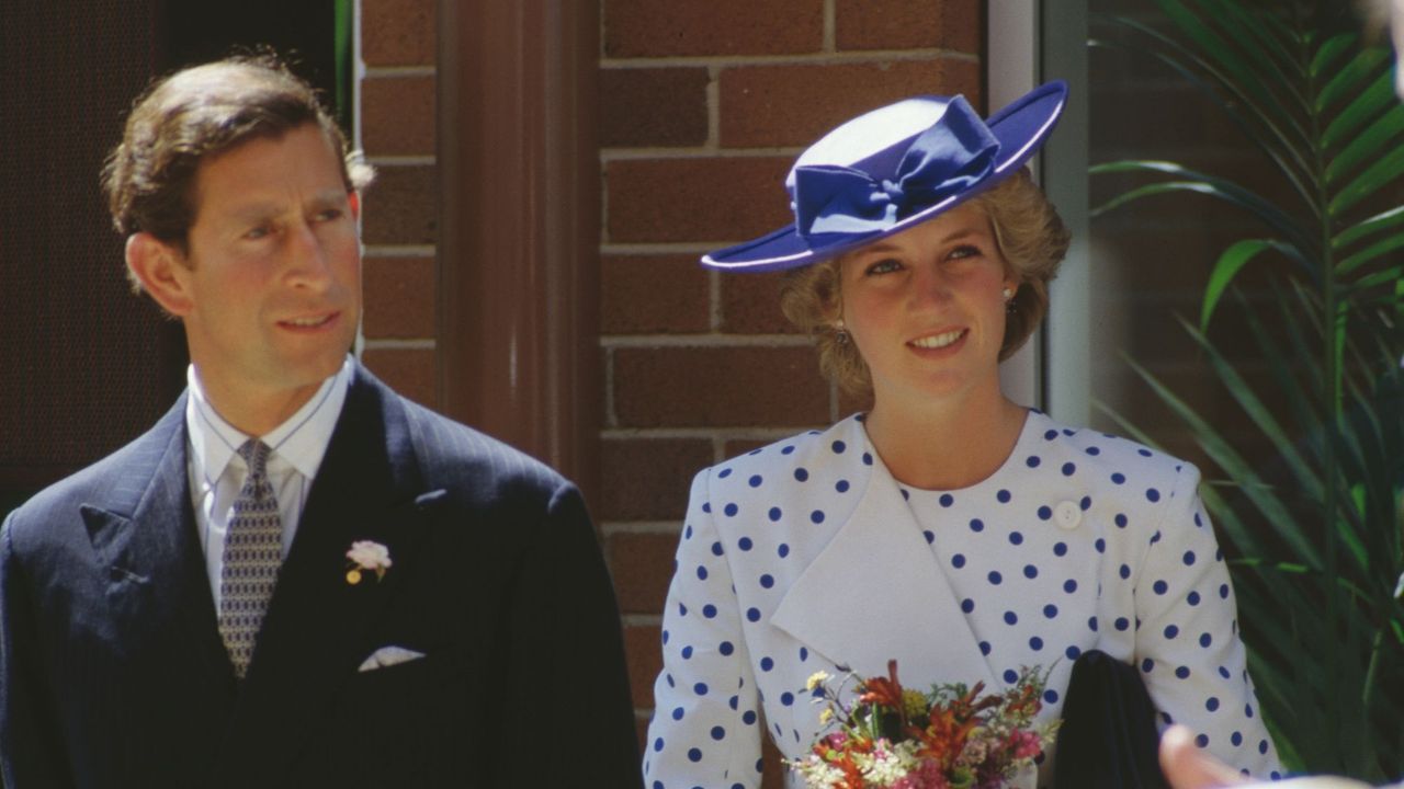 Princess Diana wears a white polka dot outfit by Jan Van Velden and a blue hat, during a visit to Canberra, Australia, with Princes Charles in 1985