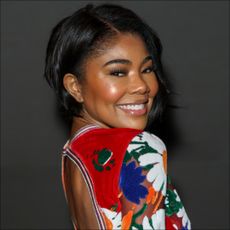 Gabrielle Union attends the Burberry show wearing a backless floral dress