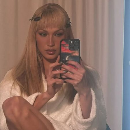 Bella Hadid getting ready with a block fringe hairstyle and hair clips in
