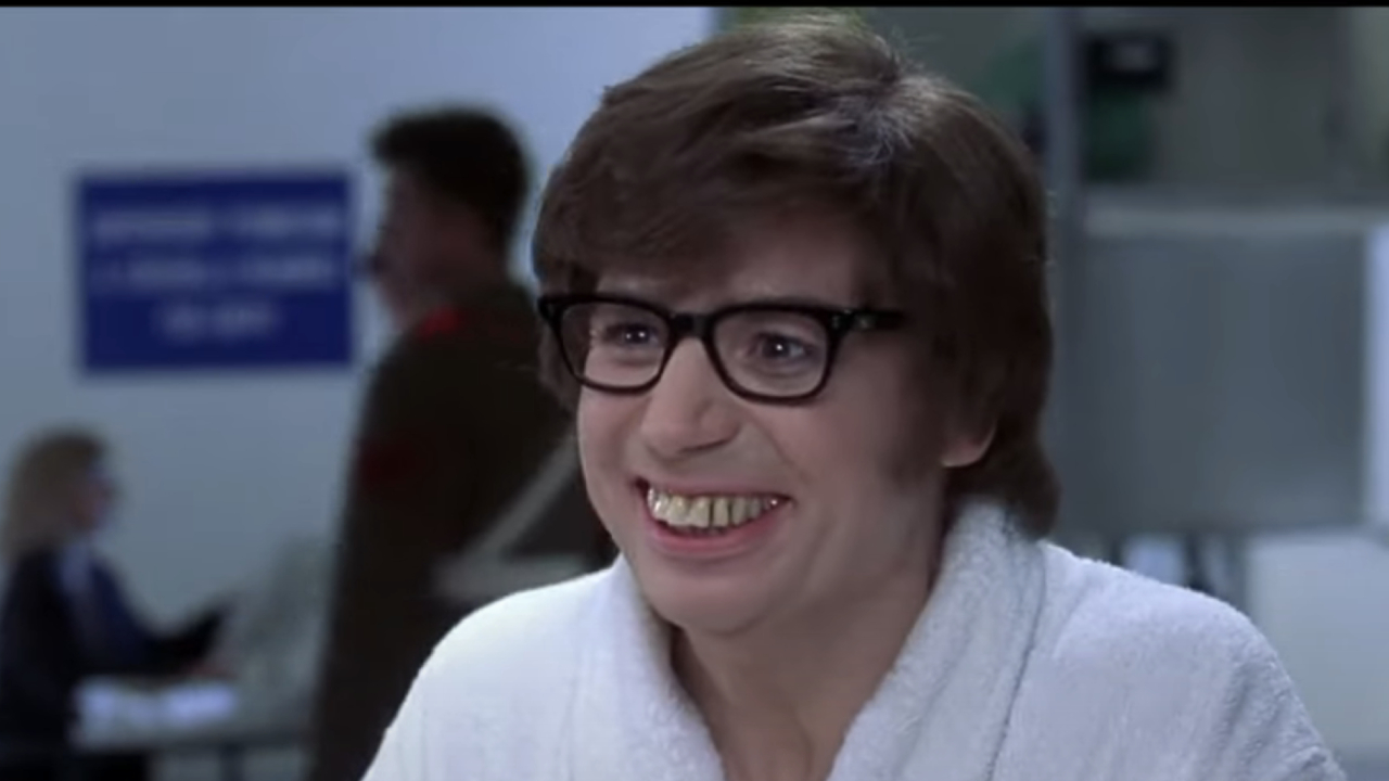 Mike Myers as Austin smiling in a robe in Austin Powers: International Man of Mystery