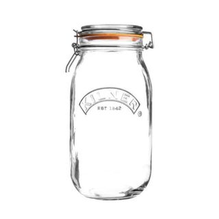 clear kilner jar with orange seal and metal clip on the lid on a white background