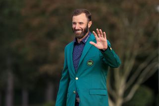 Johnson waves to the crowd after putting on the Green Jacket