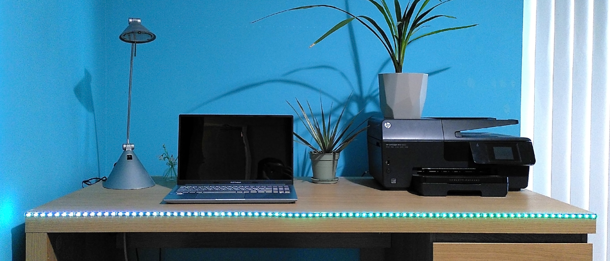 Twinkly Line smart lights on edge of desk, lit in green and blue gradient