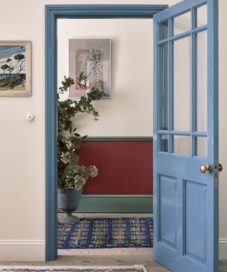 Blue painted door in white hallway