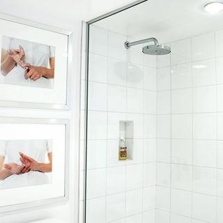 shower room with white tiles and glass partition