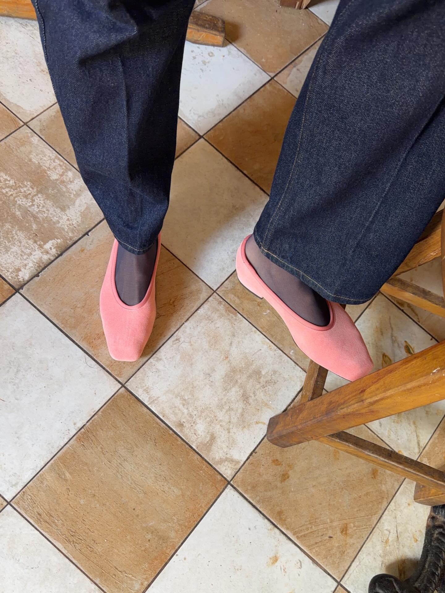 woman wearing jeans and pink shoes