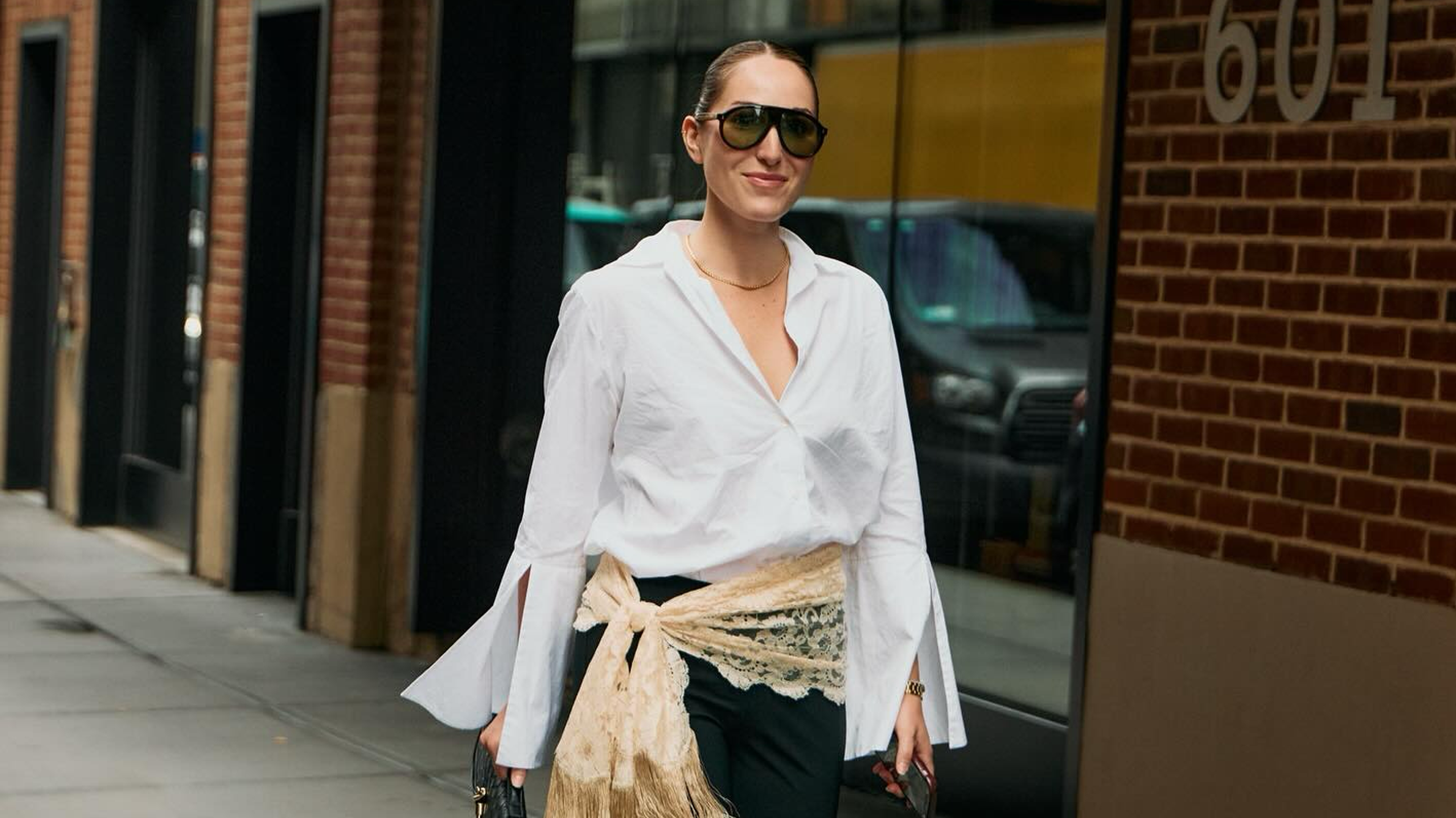 senior fashion editor Anna LaPlaca wearing a The Anteros white shirt with Moncler aviator sunglasses and a lace scarf belt