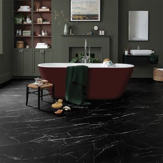 A bathroom with black marble effect floors