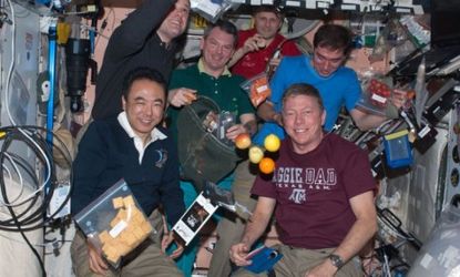 A team of astronauts show off some of their snacks: In zero gravity, astronauts crave considerably stronger flavors, including wasabi and garlic-chile paste, than they do on the ground.