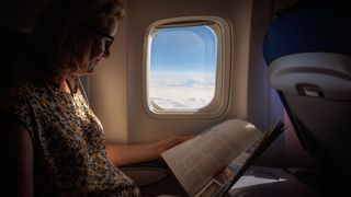 Woman traveling on a flight, booked through a package holiday