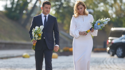 President Volodymyr Zelenskyy and wife Olena Zelenska carry flowers to mark Ukraine's independence day