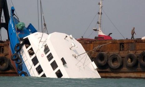 The stricken ferry is pulled out of the water near Yung Shue Wan on Lamma Island on Oct. 2 in Hong Kong.