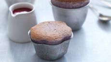 Cherry souffles in pots with jug of cherry sauce