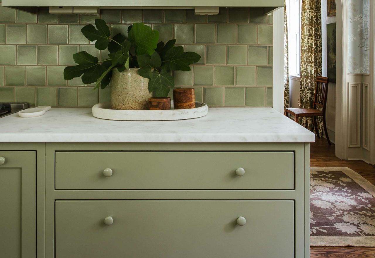 green kitchen cabinetry in a modern home