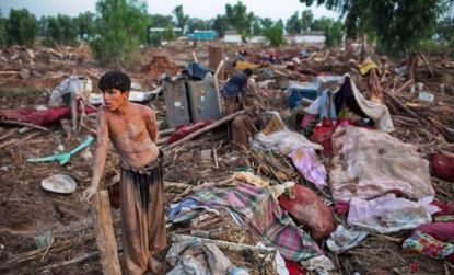 A Pakistani boy stands amid the rubble created by the worst flooding in 80 years.
