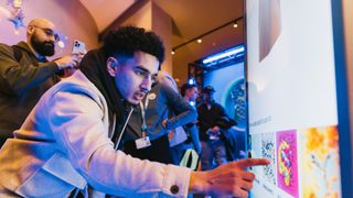 John-Anthony Disotto watching someone create a Manchester City jersey using Puma AI Creator