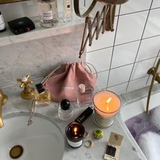 Photo of perfumes on a bathroom sink 
