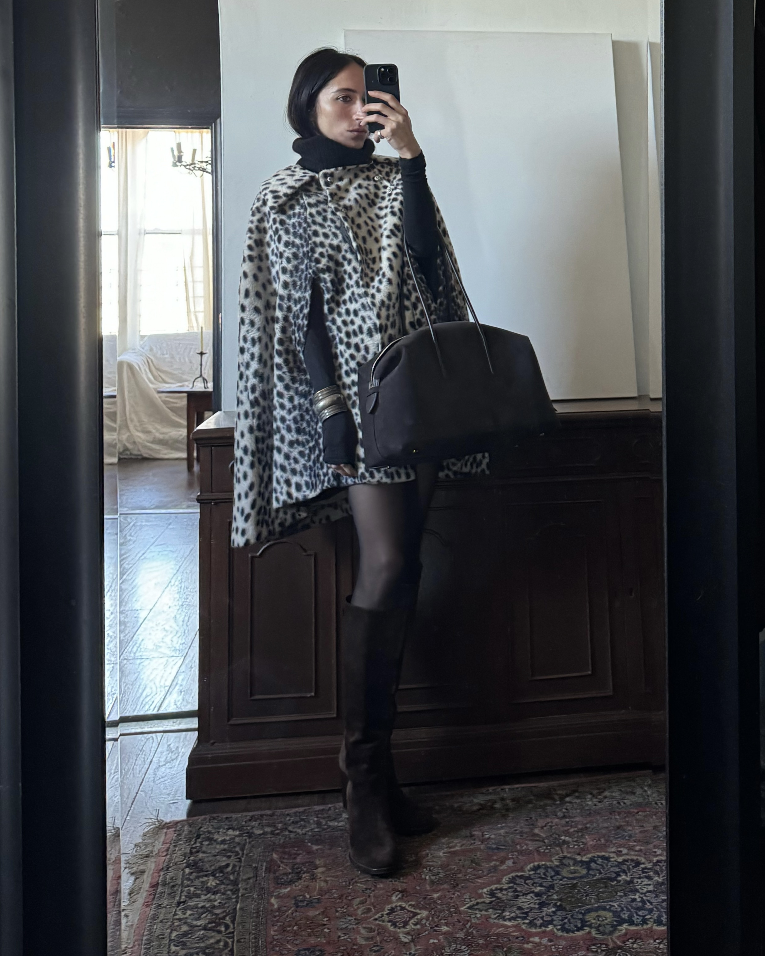 Alexis Badiyi wearing a leopard print cape