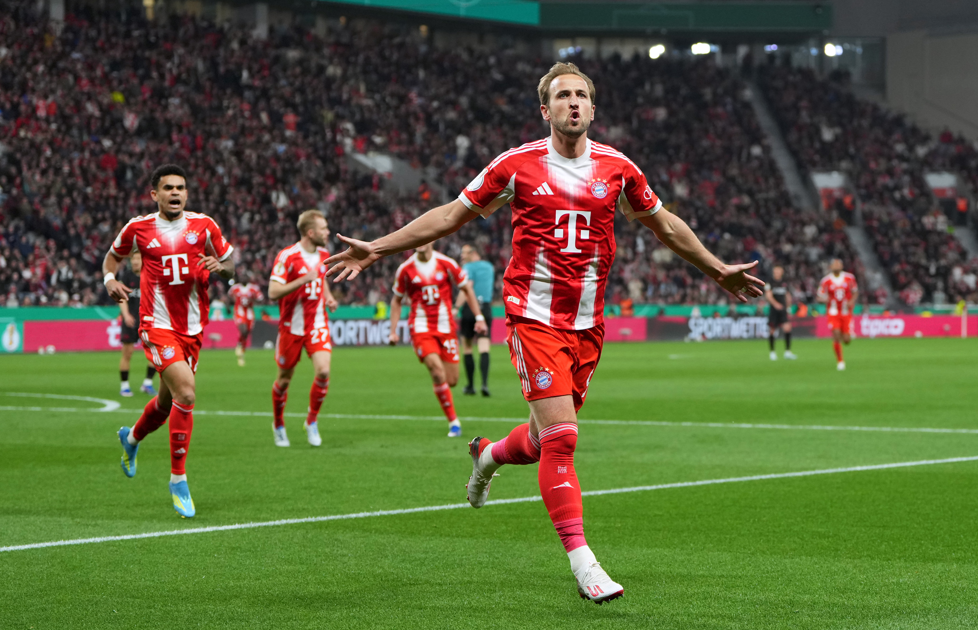 LEVERKUSEN, GERMANY - APRIL 22: Harry Kane of FC Bayern Munich celebrates scoring his team's first goal during the DFB Cup semifinal match between Bayer 04 Leverkusen and FC Bayern M&uuml;nchen at BayArena on April 22, 2026 in Leverkusen, Germany. (Photo by Pau Barrena/Getty Images)