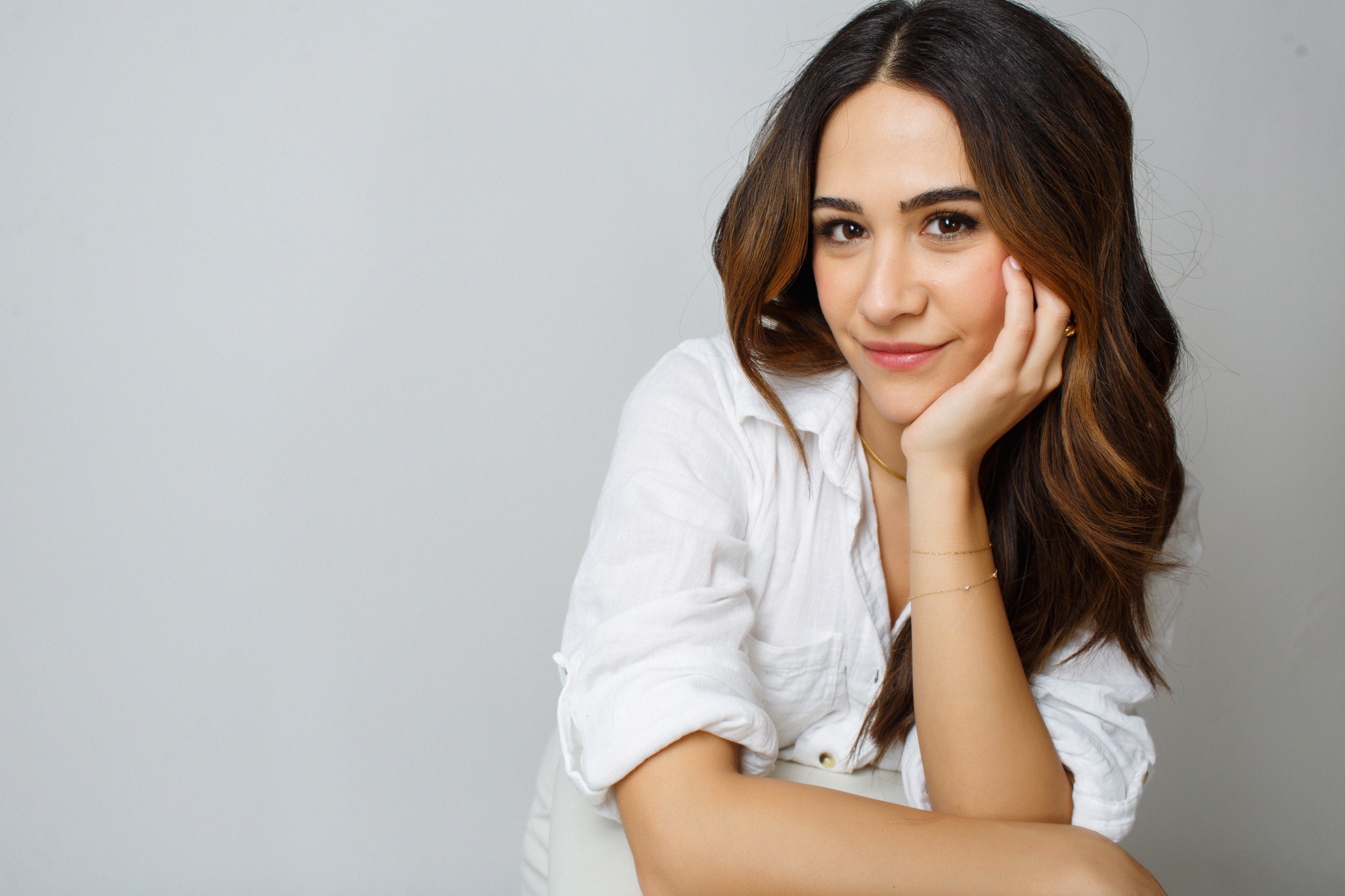 a mexican woman with brown hair in a white shirt