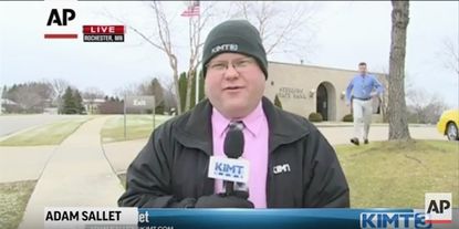 Adam Sallet reports live during a bank robbery in Rochester, Minnesota.