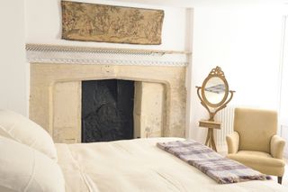 Traditional bedroom in period home with fireplace