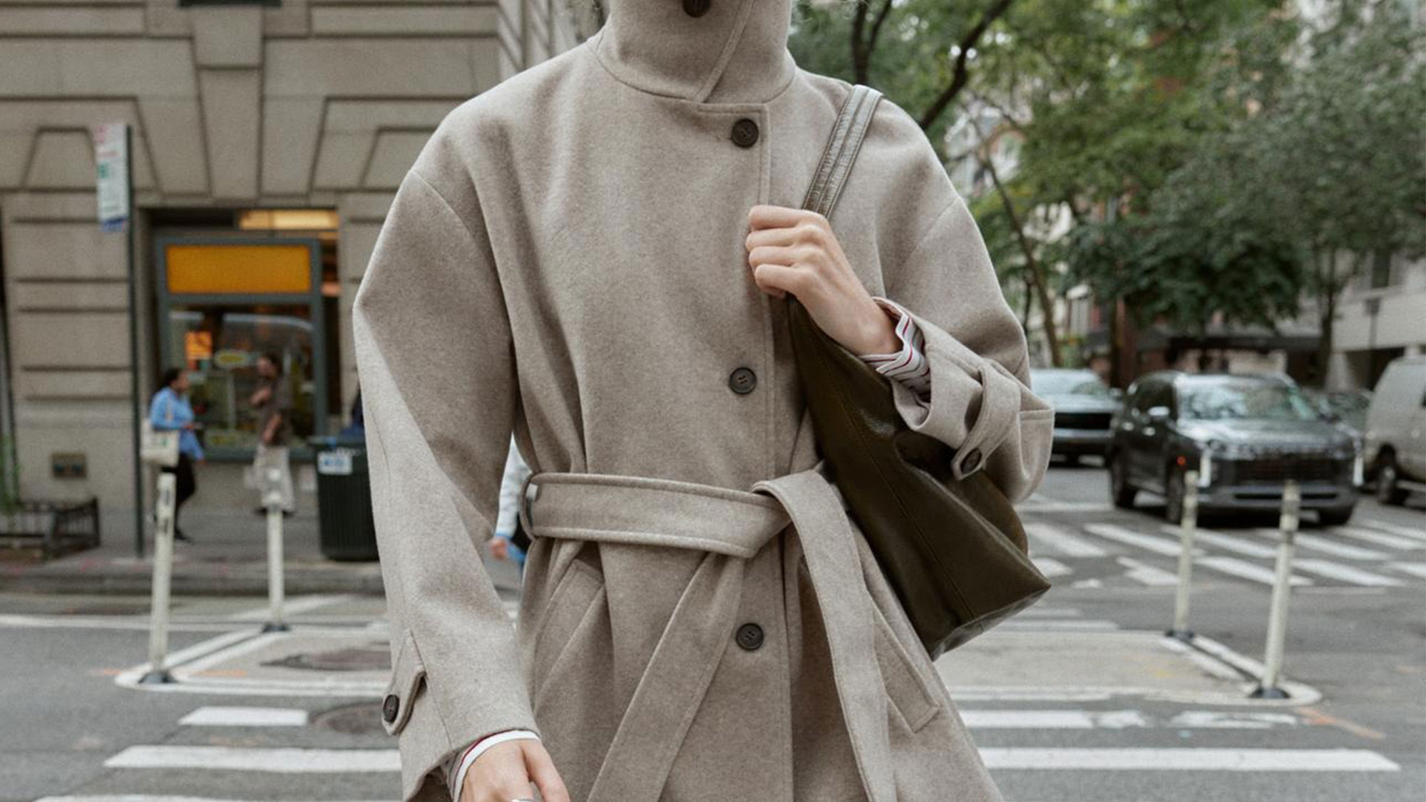 A Zara model wearing a belted funnel neck coat.