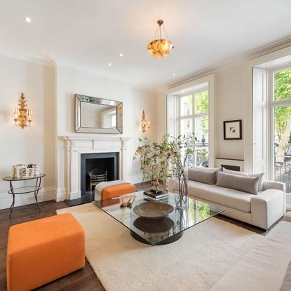 living room with fireplace white walls and sofa set with cushion