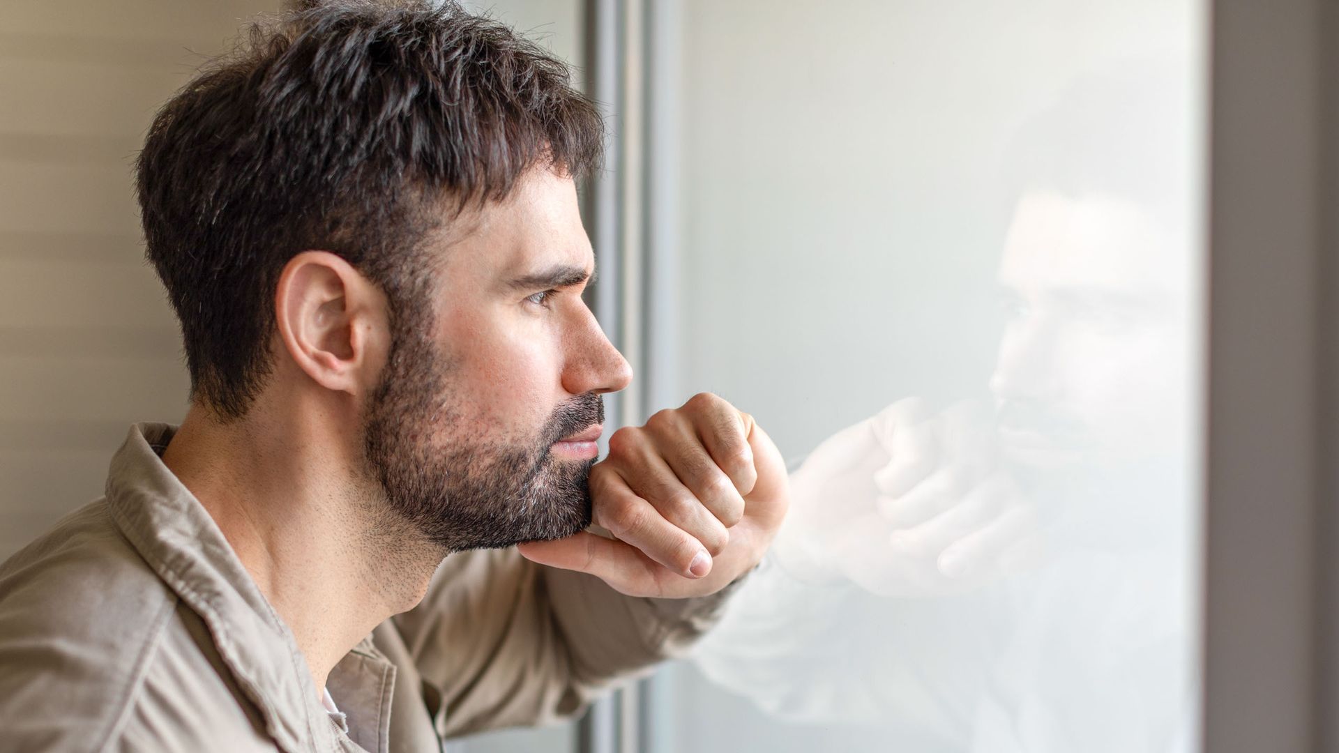 man looking out of window